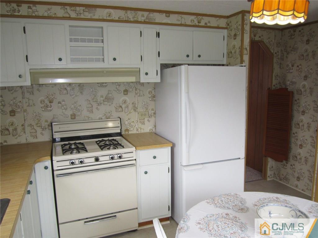 36 Whitman Road, Unit 1 North Brunswick, NJ 08902 - Photo 8 of 18 a kitchen with a refrigerator and a stove
