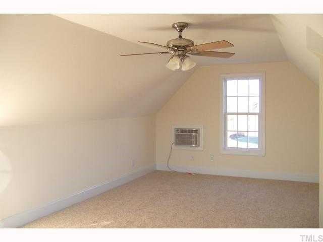 22 Long Ridge Court Willow Spring, NC 27592 - Photo 8 of 11 Bonus room is separate from the rest of the house with cathedral ceiling, ceiling fan and heating/cooling unit with remote control. Bonus Room