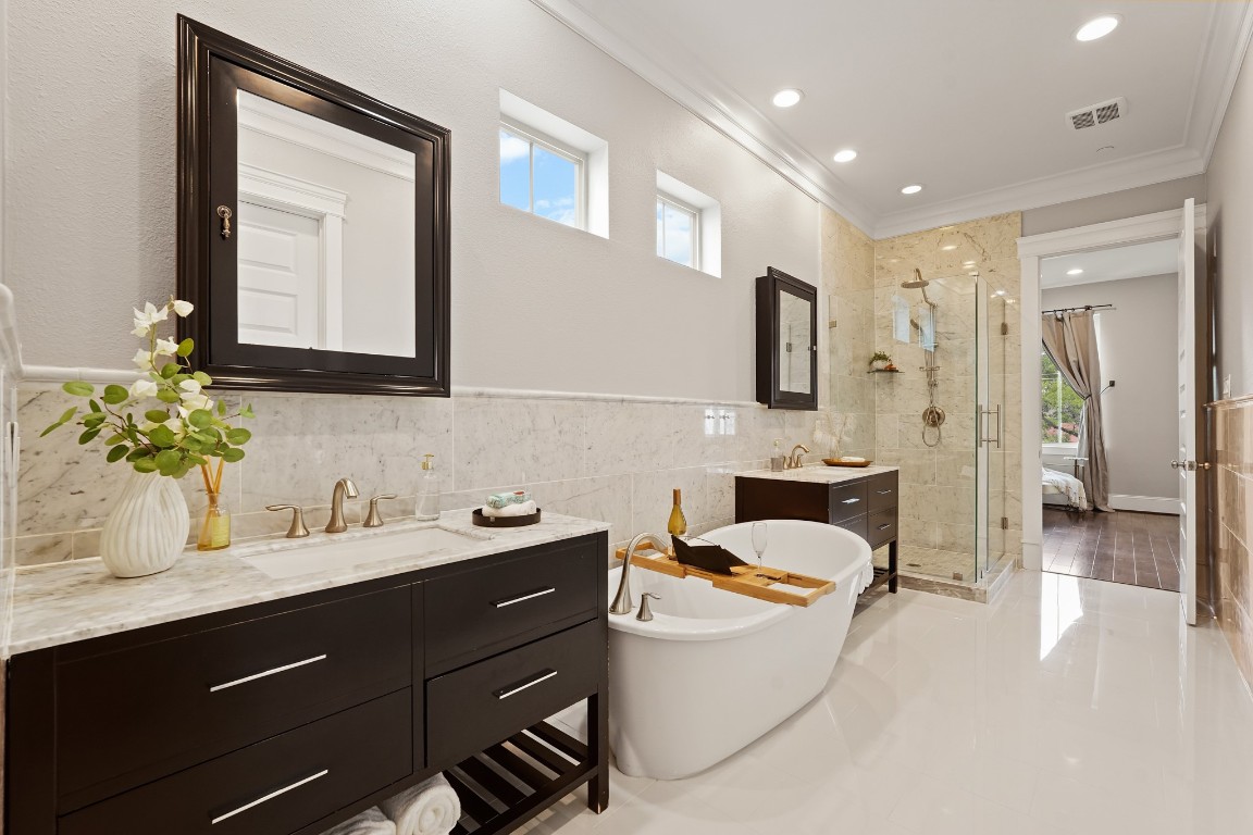 1812 Rosedale Street, Unit A Houston, TX 77004 - Photo 12 of 21 Primary bath featuring a soaking tub, walk-in shower, dual vanities, and natural light.