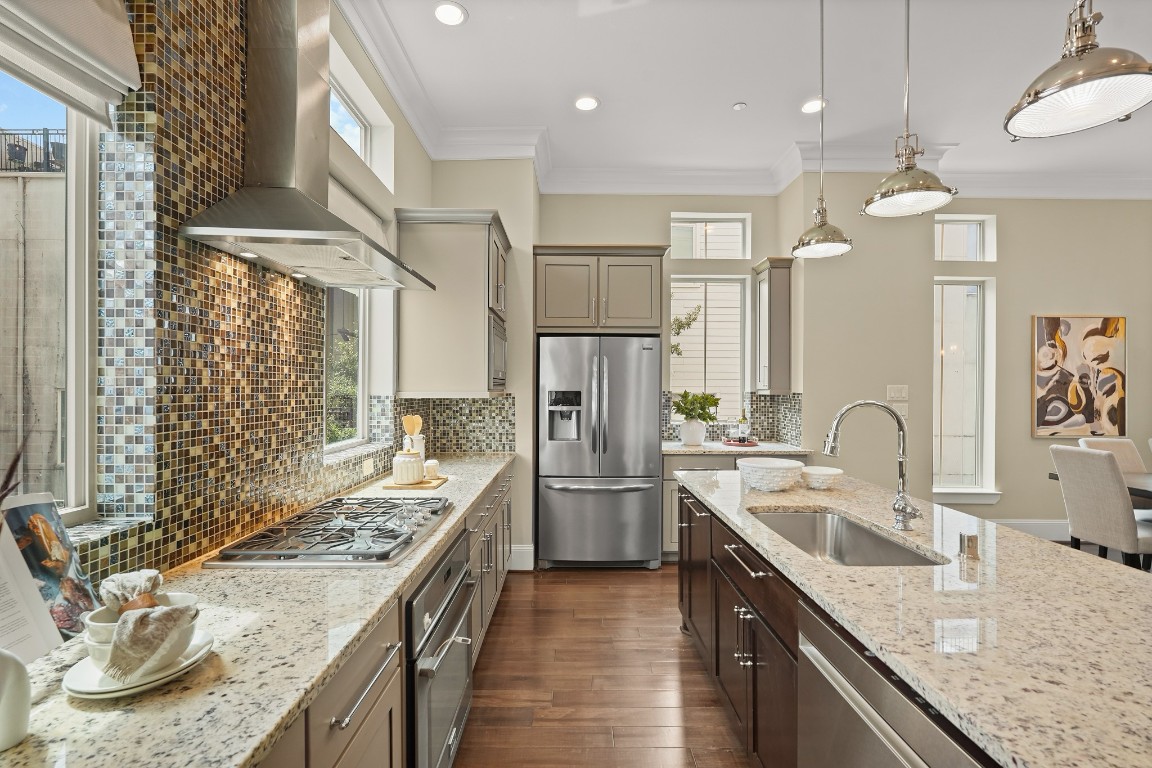 1812 Rosedale Street, Unit A Houston, TX 77004 - Photo 6 of 21 Expansive windows flood the kitchen with natural light, highlighting upgraded finishes and modern countertops.
