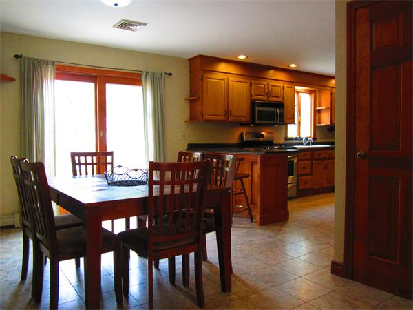 30 Sandy Beach Road Plymouth, MA 02360 - Photo 7 of 26 a dining room with a table chairs and a kitchen