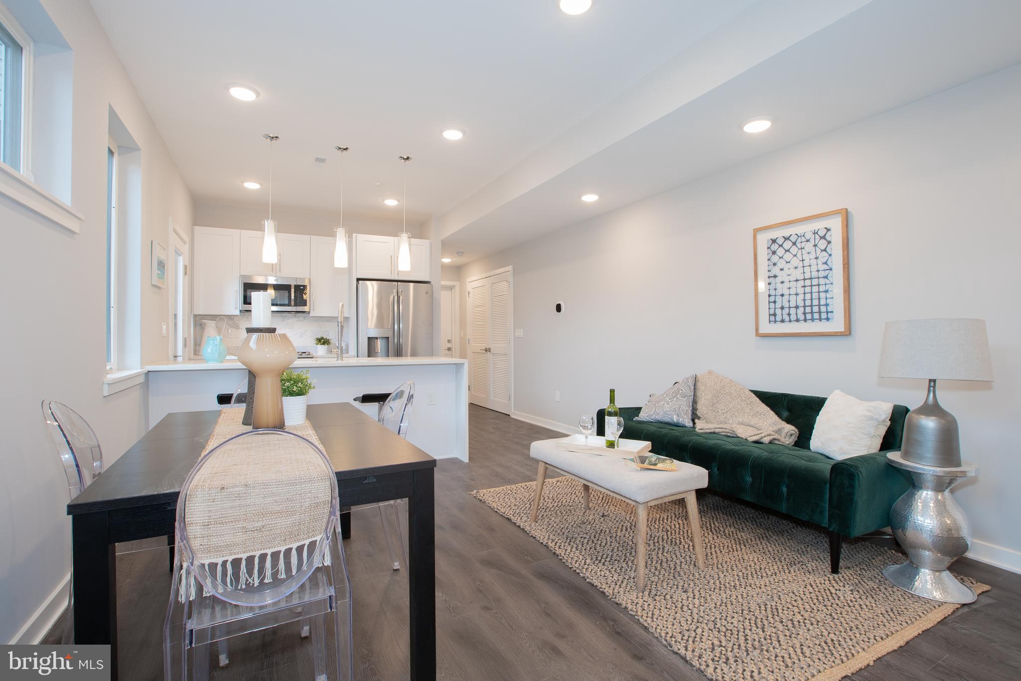 a living room with kitchen island furniture and a chandelier
