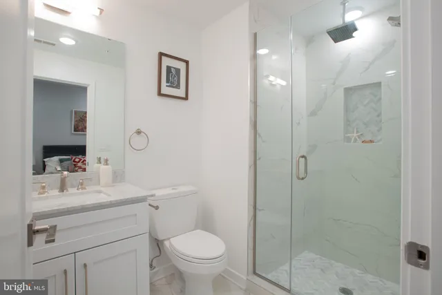 a bathroom with a sink toilet and shower