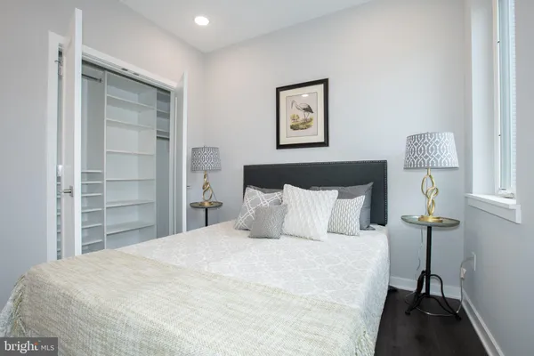 a bedroom with a bed and a lamp on table