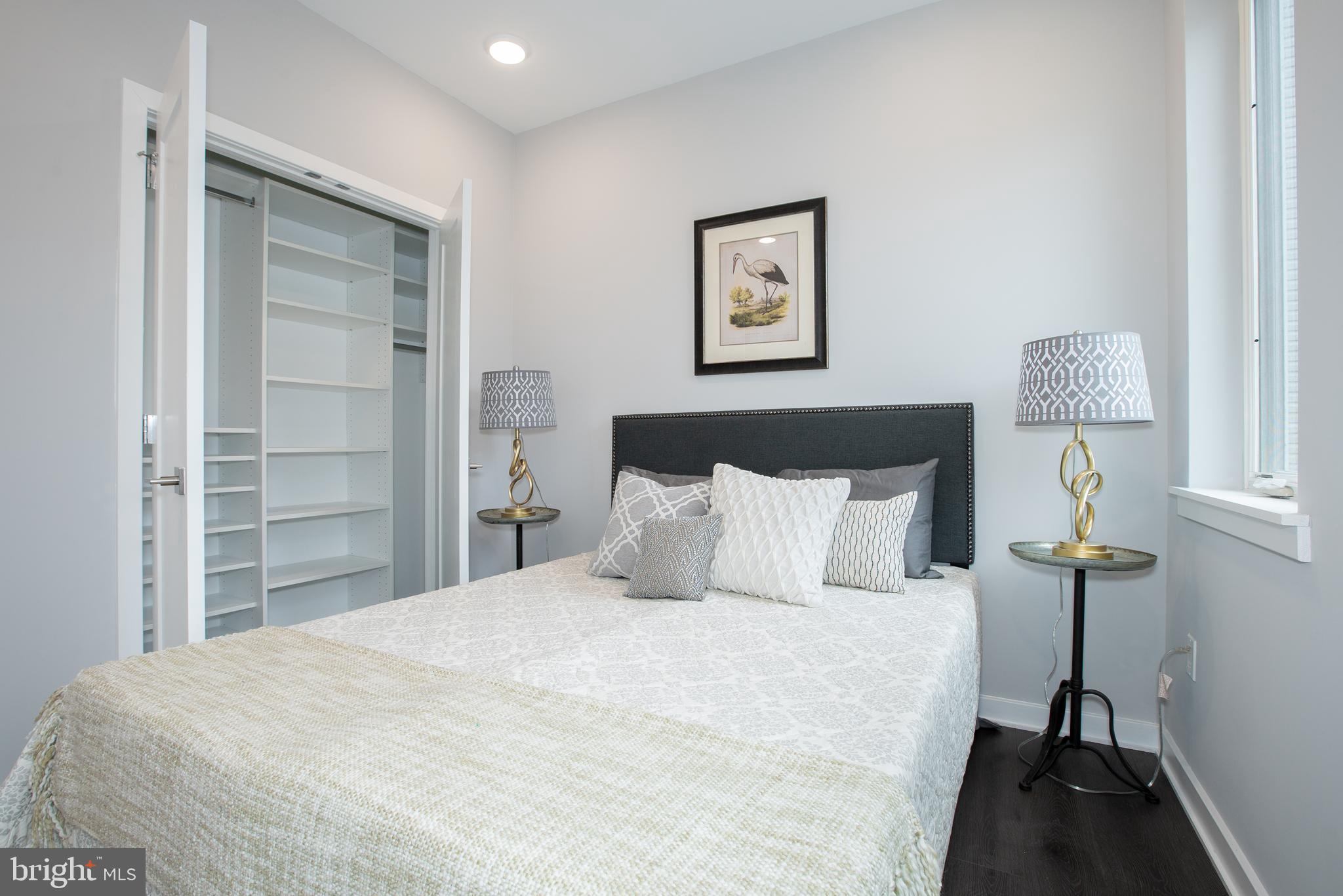 1534 Ridge Avenue, Unit 502 Philadelphia, PA 19130 - Photo 6 of 20 a bedroom with a bed and a lamp on table