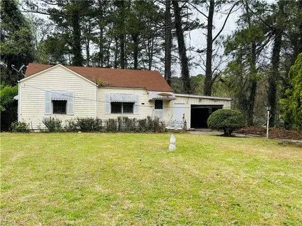 a front view of house with yard and trees