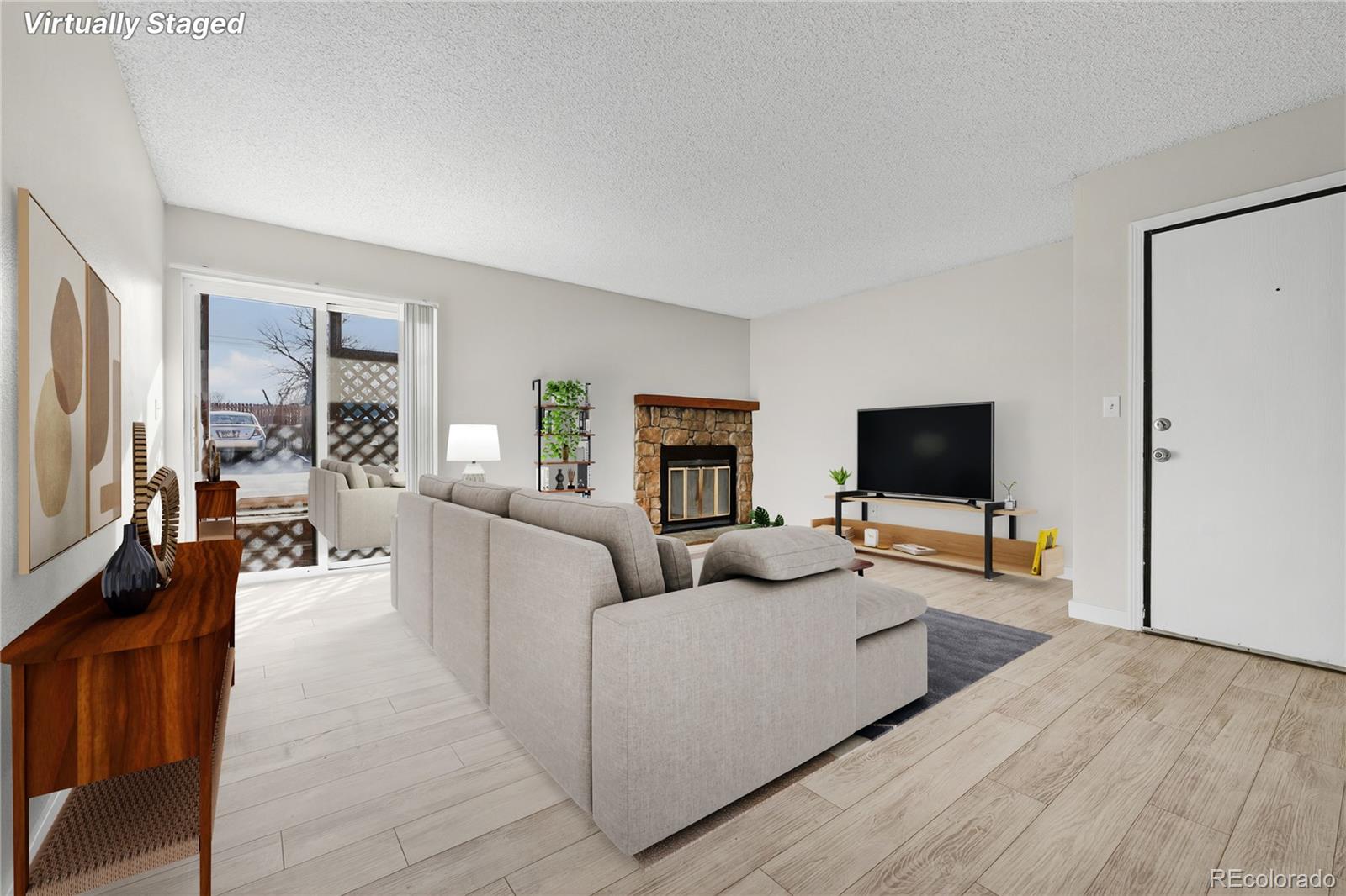 4681 South Decatur Street, Unit 124 Englewood, CO 80110 - Photo 1 of 33 a living room with furniture and a flat screen tv