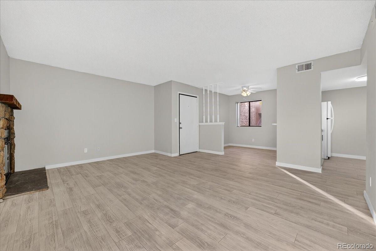 4681 South Decatur Street, Unit 124 Englewood, CO 80110 - Photo 11 of 33 a view of an empty room with wooden floor and a window
