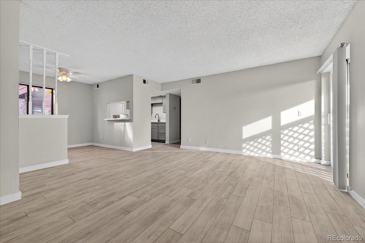 4681 South Decatur Street, Unit 124 Englewood, CO 80110 - Photo 12 of 33 a view of an empty room with wooden floor and a window