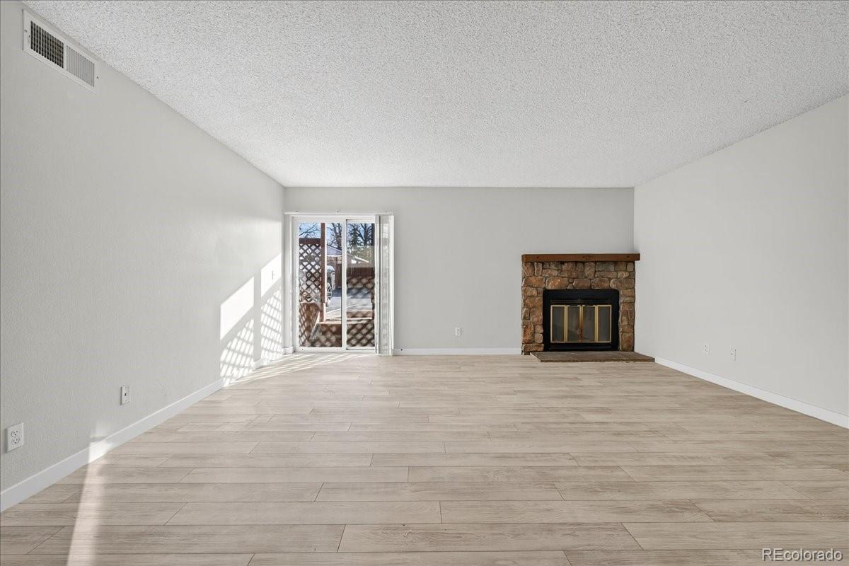 4681 South Decatur Street, Unit 124 Englewood, CO 80110 - Photo 13 of 33 a view of an empty room with a window and fireplace