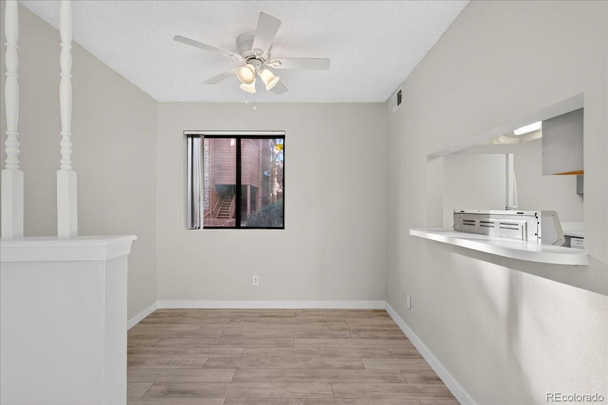 4681 South Decatur Street, Unit 124 Englewood, CO 80110 - Photo 16 of 33 a view of a kitchen with a sink a ceiling fan and wooden floor
