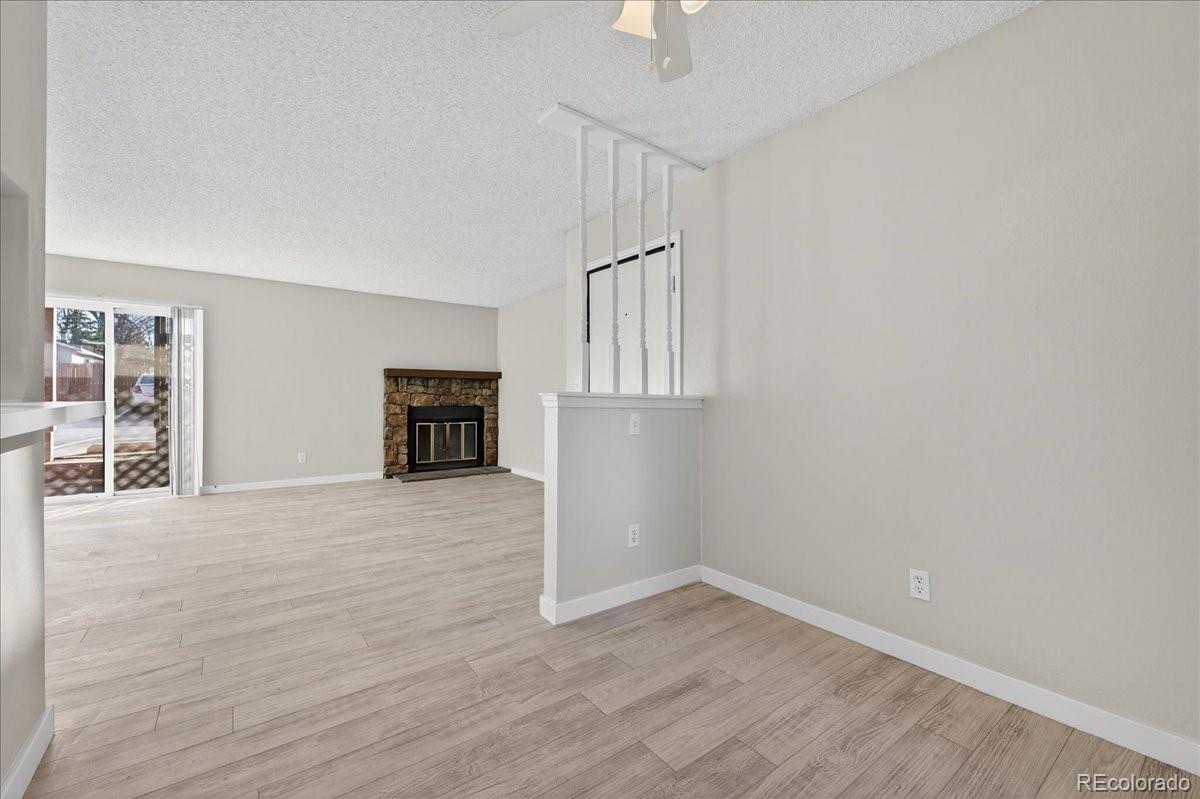 4681 South Decatur Street, Unit 124 Englewood, CO 80110 - Photo 17 of 33 a view of an empty room with wooden floor kitchen and a window