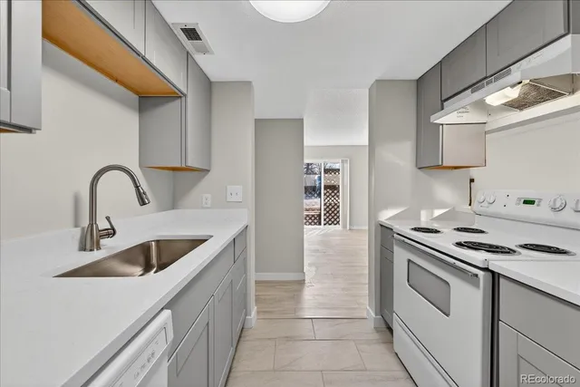 a kitchen with cabinets a sink and appliances