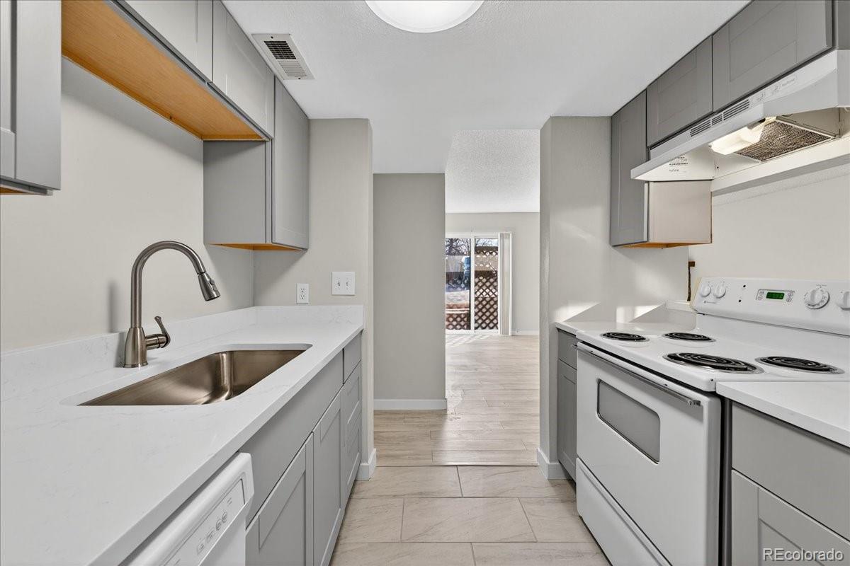 4681 South Decatur Street, Unit 124 Englewood, CO 80110 - Photo 19 of 33 a kitchen with cabinets a sink and appliances