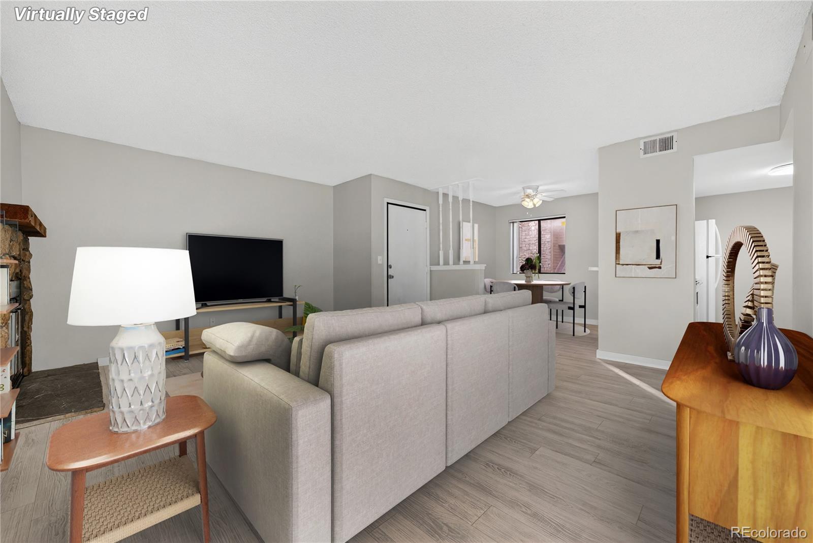 4681 South Decatur Street, Unit 124 Englewood, CO 80110 - Photo 2 of 33 a living room with furniture and a flat screen tv