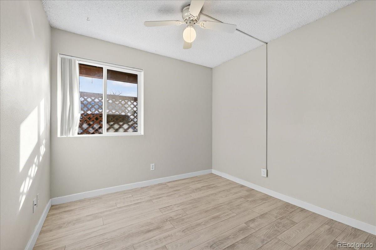 4681 South Decatur Street, Unit 124 Englewood, CO 80110 - Photo 21 of 33 an empty room with wooden floor fan and windows