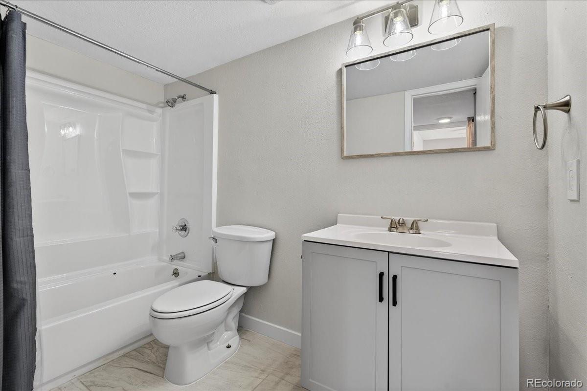 4681 South Decatur Street, Unit 124 Englewood, CO 80110 - Photo 27 of 33 a bathroom with a toilet a sink and a mirror
