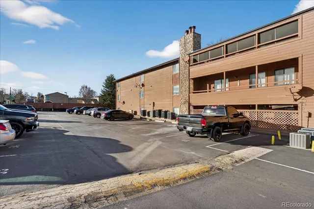 a view of building with car parked