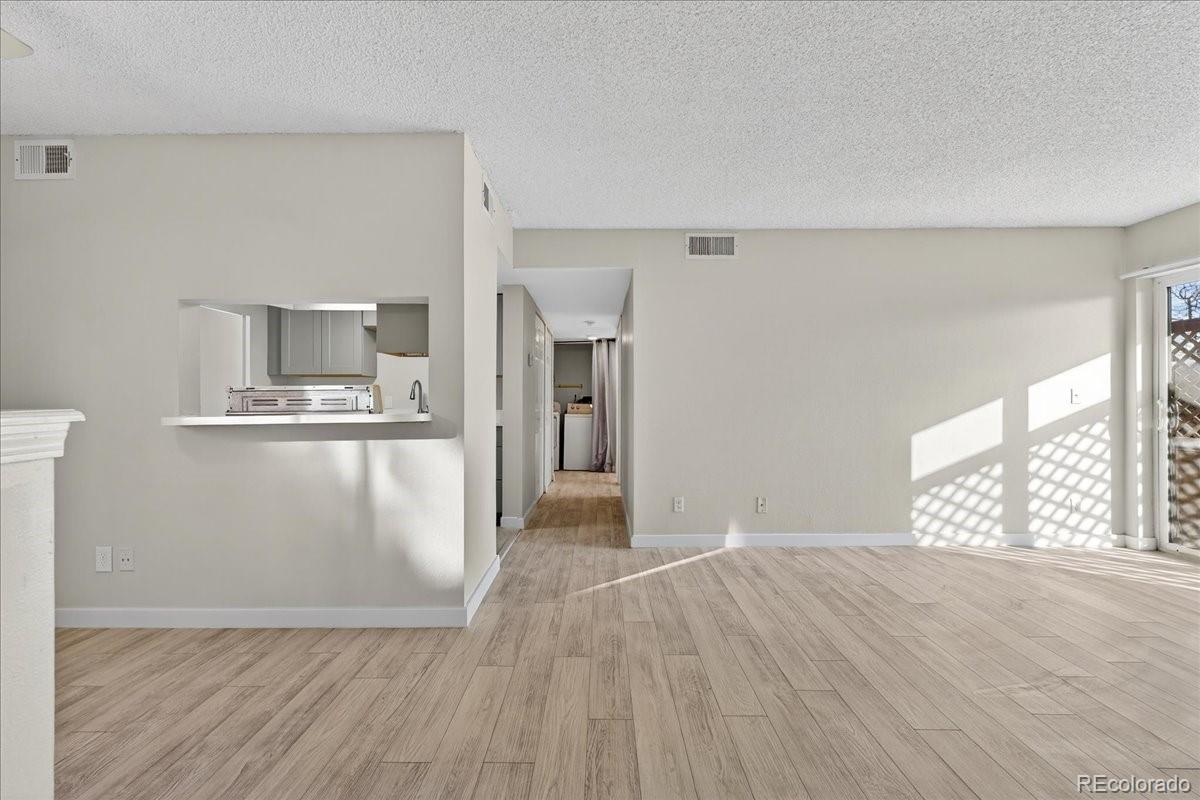 4681 South Decatur Street, Unit 124 Englewood, CO 80110 - Photo 9 of 33 a view of kitchen with furniture and wooden floor