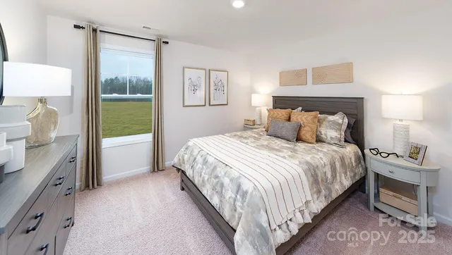 a bedroom with a bed and a lamp