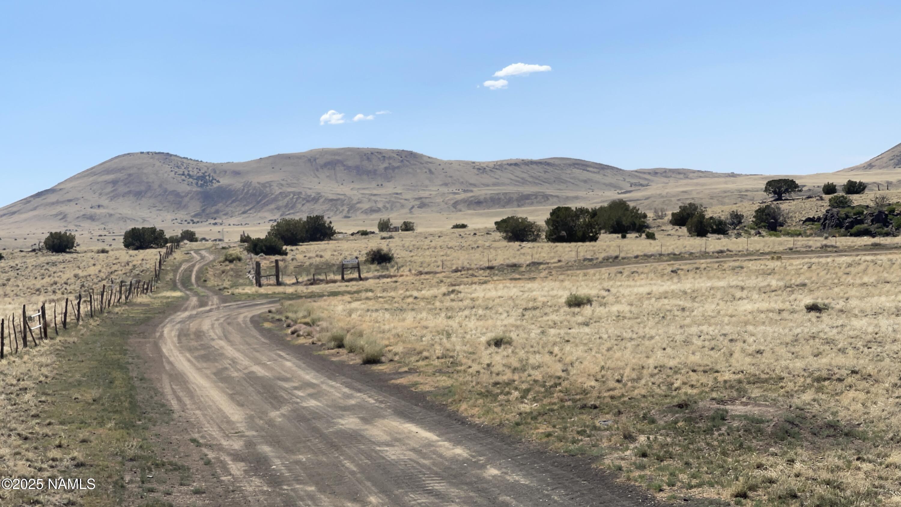 a view of a large mountains with green field and mountains