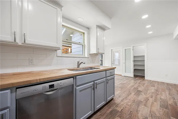a kitchen with a sink cabinets and window