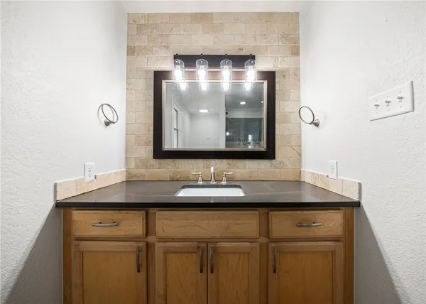 a bathroom with a sink and a mirror