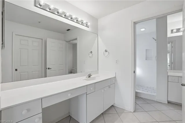 a bathroom with a double vanity sink and a mirror