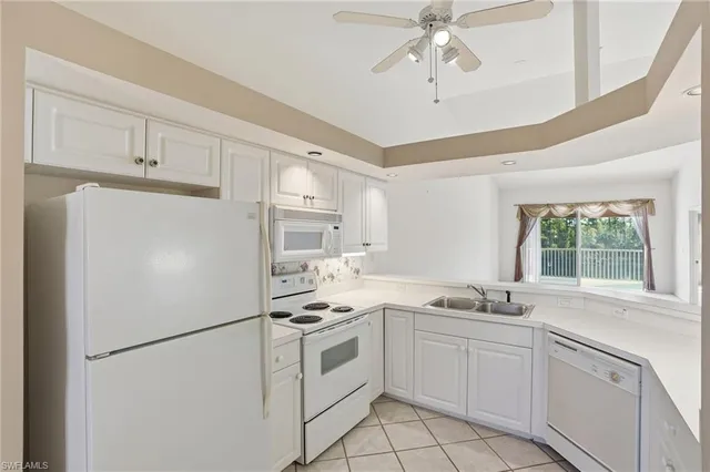 a white refrigerator freezer sitting inside of a kitchen