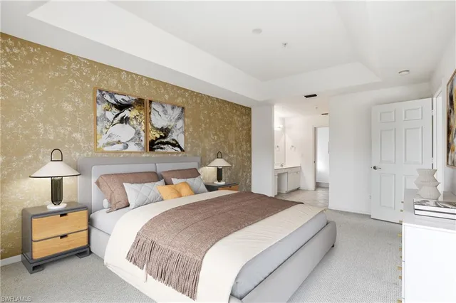 a bedroom with a bed and a painting on the wall