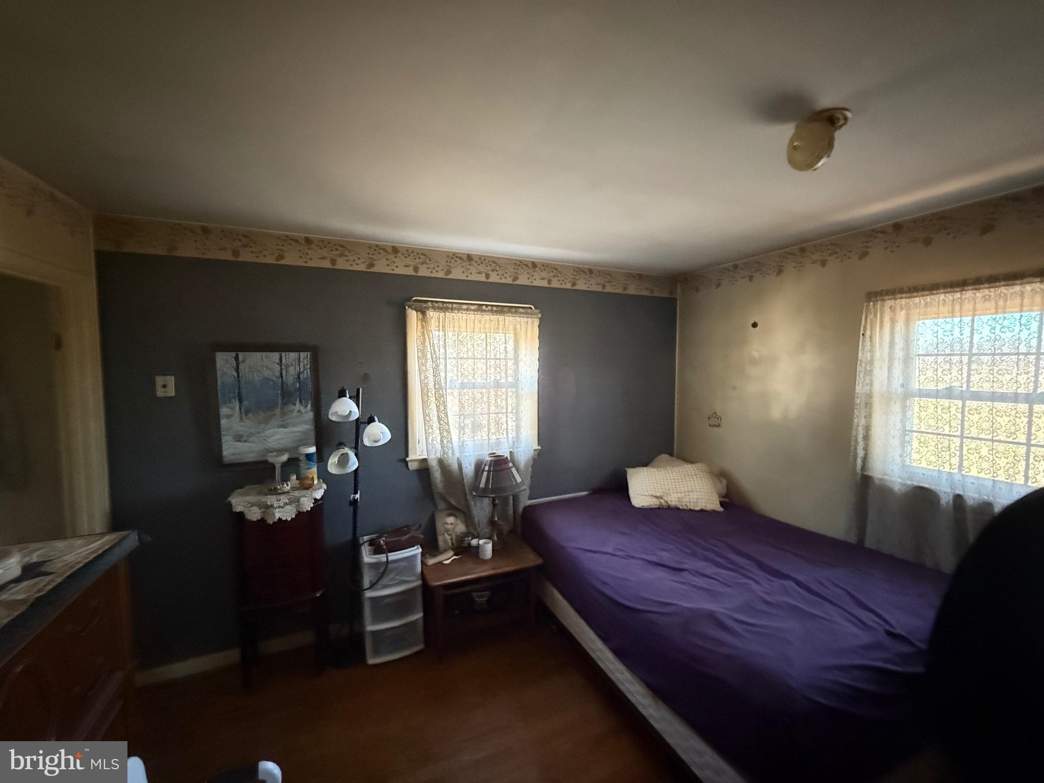 1400 Spencerville Road Spencerville, MD 20868 - Photo 7 of 16 a bedroom with a bed and wooden floor