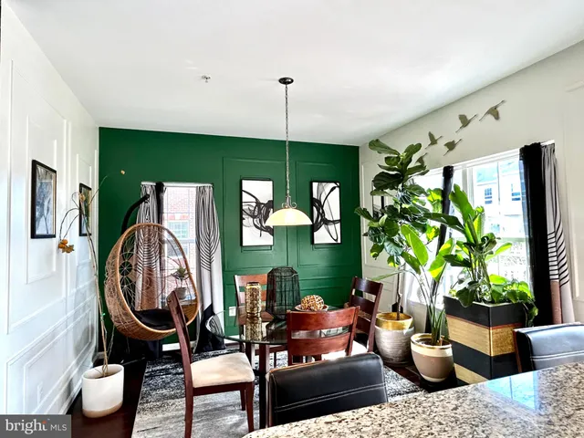 a living room with furniture a window and a flat screen tv