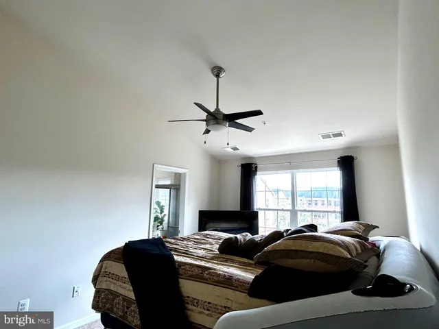 a bedroom with a bed and window