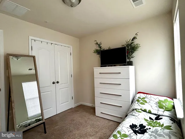 a bedroom with a bed and a television