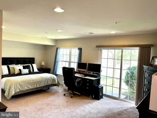 a bedroom with a bed dresser and a window