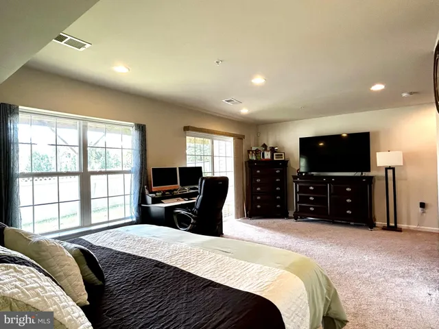 a bedroom with a bed and a television