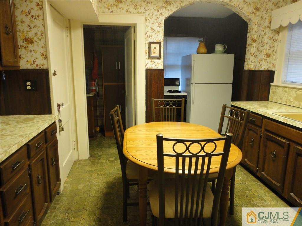 106 Walker Road West Orange, NJ 07052 - Photo 12 of 25 a kitchen with stainless steel appliances a refrigerator a stove a sink and a dining table