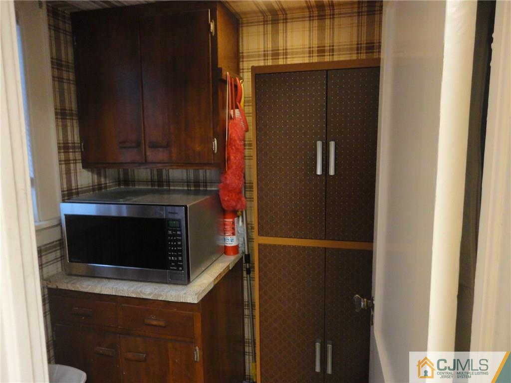 106 Walker Road West Orange, NJ 07052 - Photo 13 of 25 a kitchen with granite countertop a refrigerator and a stove