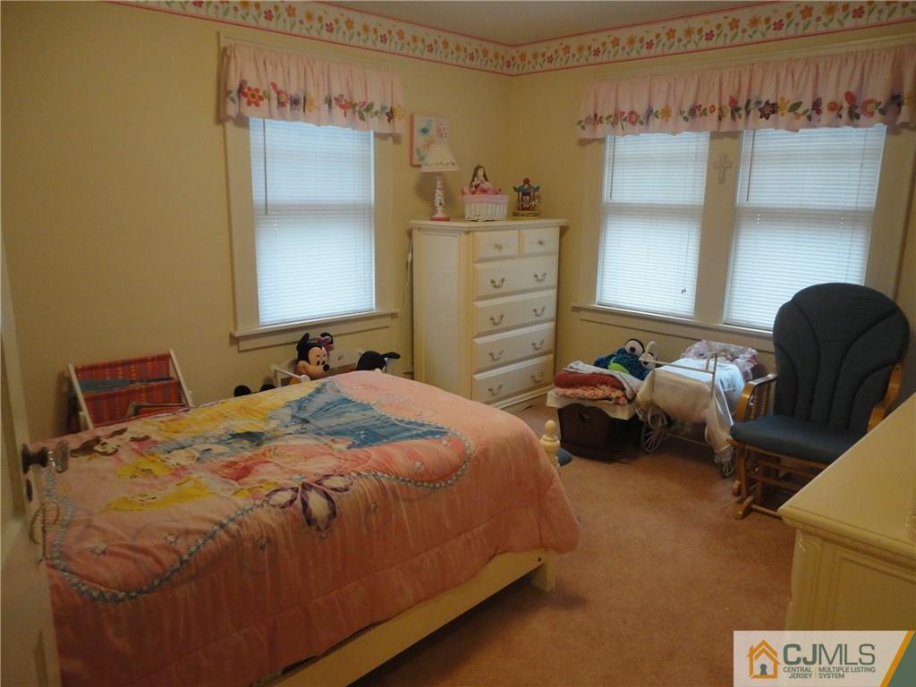 106 Walker Road West Orange, NJ 07052 - Photo 15 of 25 a bedroom with a bed and a chair
