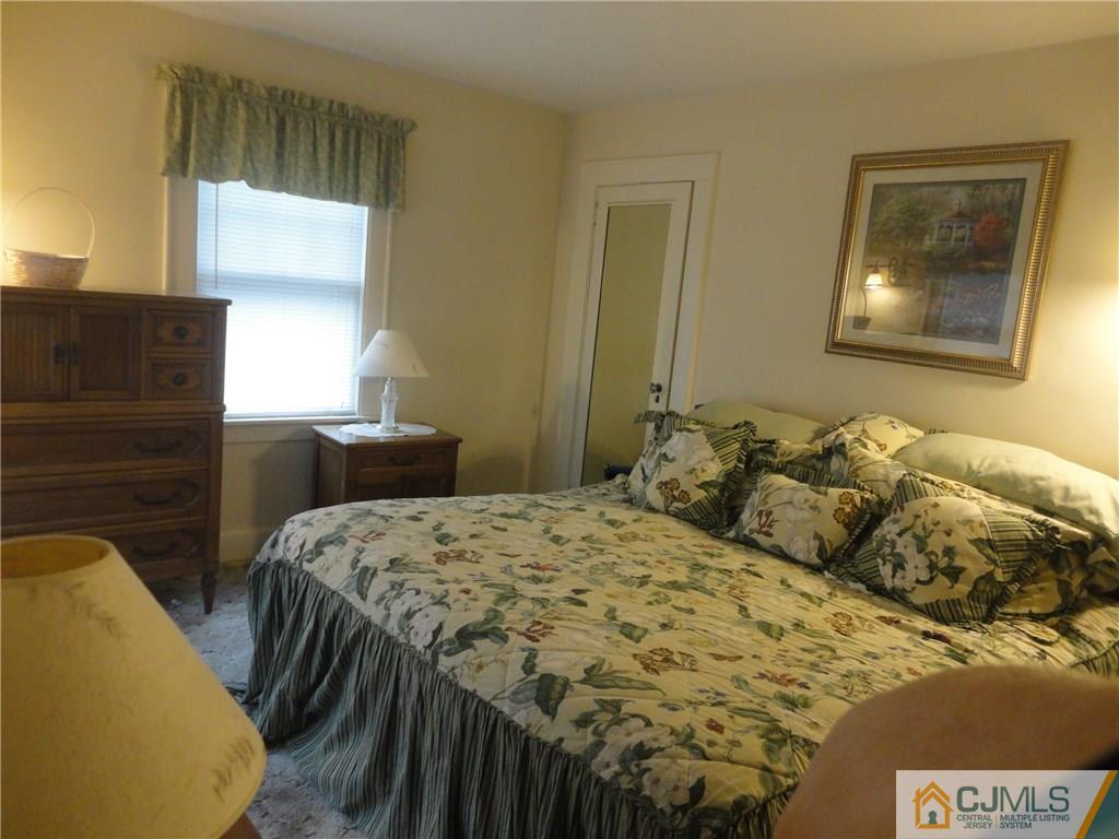 106 Walker Road West Orange, NJ 07052 - Photo 19 of 25 a bedroom with a bed and a painting on the wall