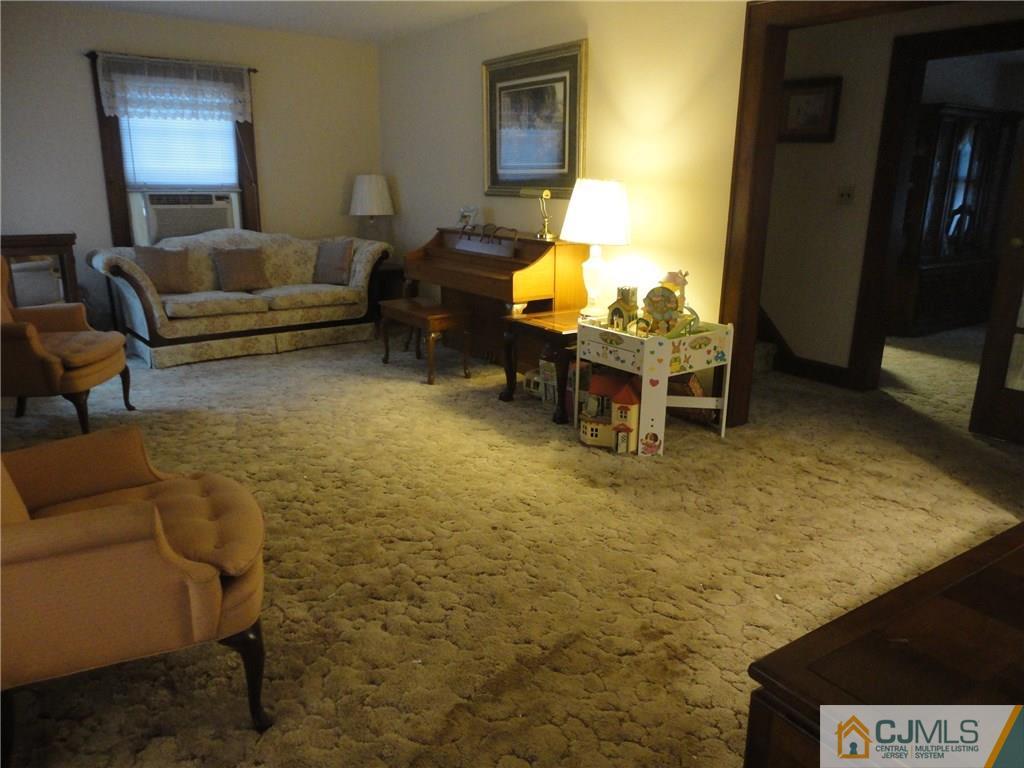 106 Walker Road West Orange, NJ 07052 - Photo 4 of 25 a living room with furniture and a window