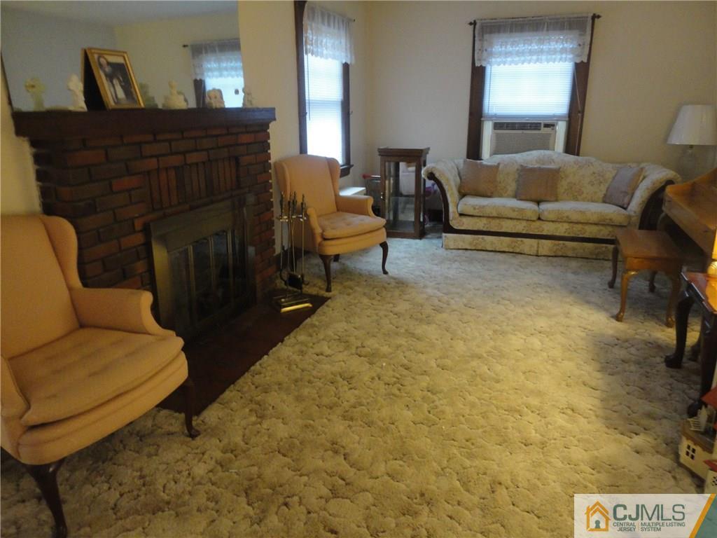 106 Walker Road West Orange, NJ 07052 - Photo 5 of 25 a living room with furniture and a fireplace