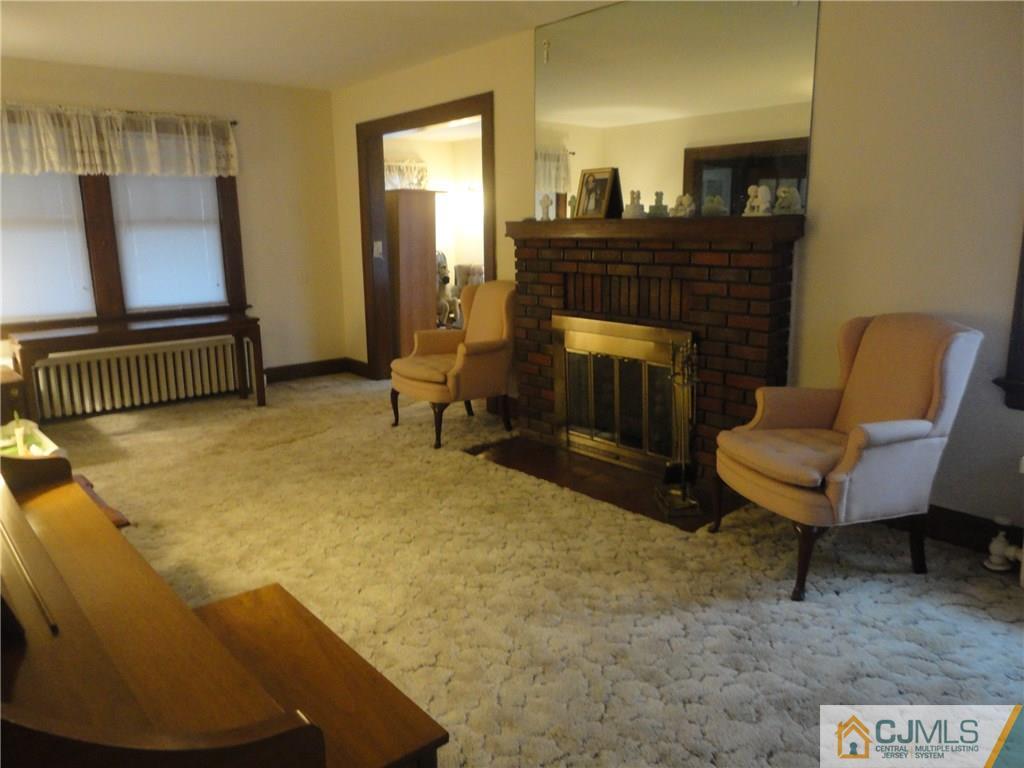106 Walker Road West Orange, NJ 07052 - Photo 6 of 25 a living room with furniture and a fireplace