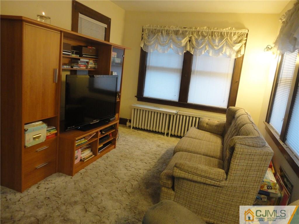 106 Walker Road West Orange, NJ 07052 - Photo 7 of 25 a living room with furniture and a flat screen tv
