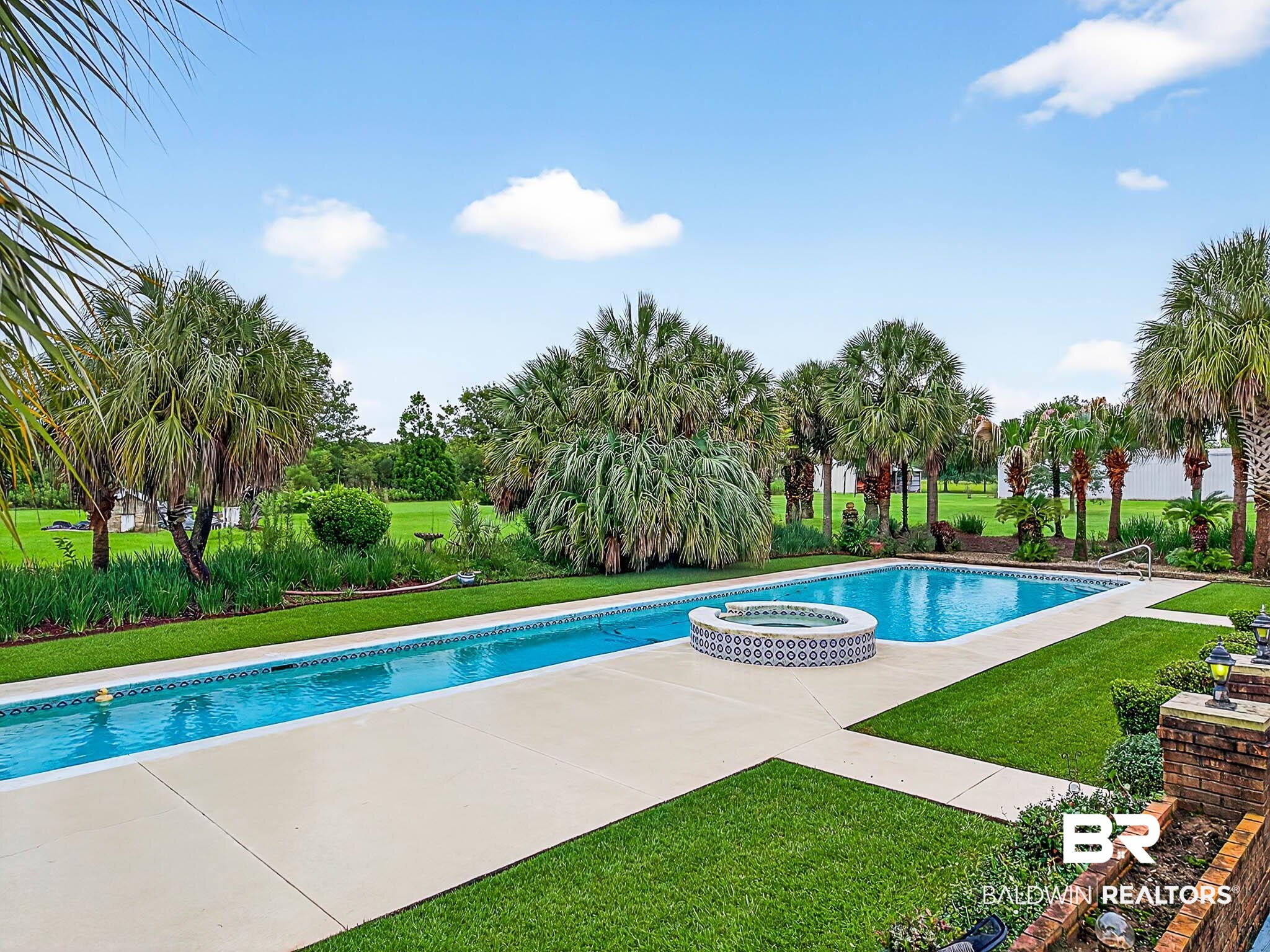17270 Davis Road Summerdale, AL 36580 - Photo 41 of 97 View of pool featuring a lawn, a patio area, and a pool with connected hot tub