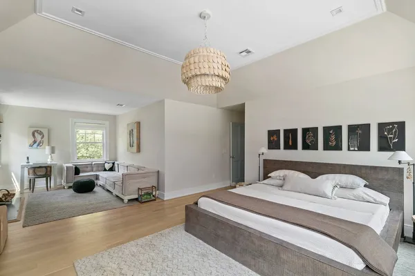 a spacious bedroom with a bed and a large window