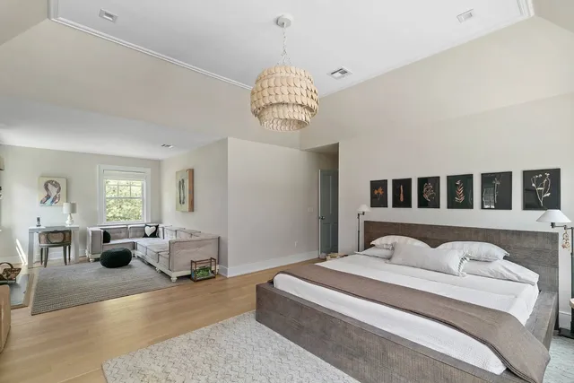 a spacious bedroom with a bed and a large window