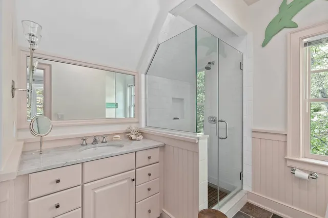 a bedroom with a bed lamp and a window