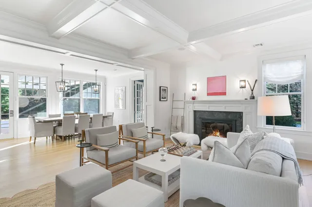 a living room with furniture large window and a fireplace
