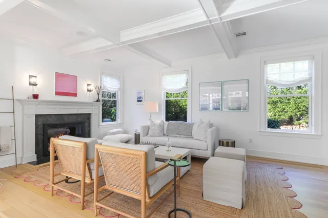 a living room with furniture a window and a fireplace